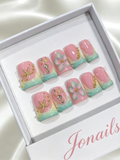 Pink to mint green ombre press-on nails with 3D white flowers, gold starfish charm and crystal shell rhinestones