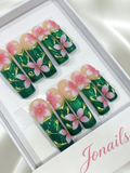 Emerald green glitter press-on nails with 3D pink flowers and gold leaf vein details