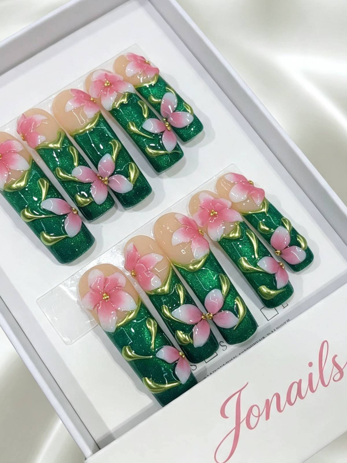 Emerald green glitter press-on nails with 3D pink flowers and gold leaf vein details